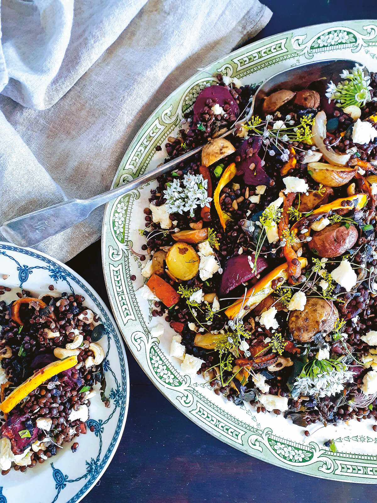 Salat aus gebratenem Gemüse und schwarzen Linsen mit frischen Kräutern und Ziegenkäse